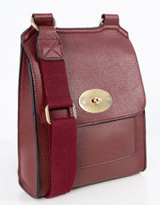 An image showing a wine coloured messenger bag.
