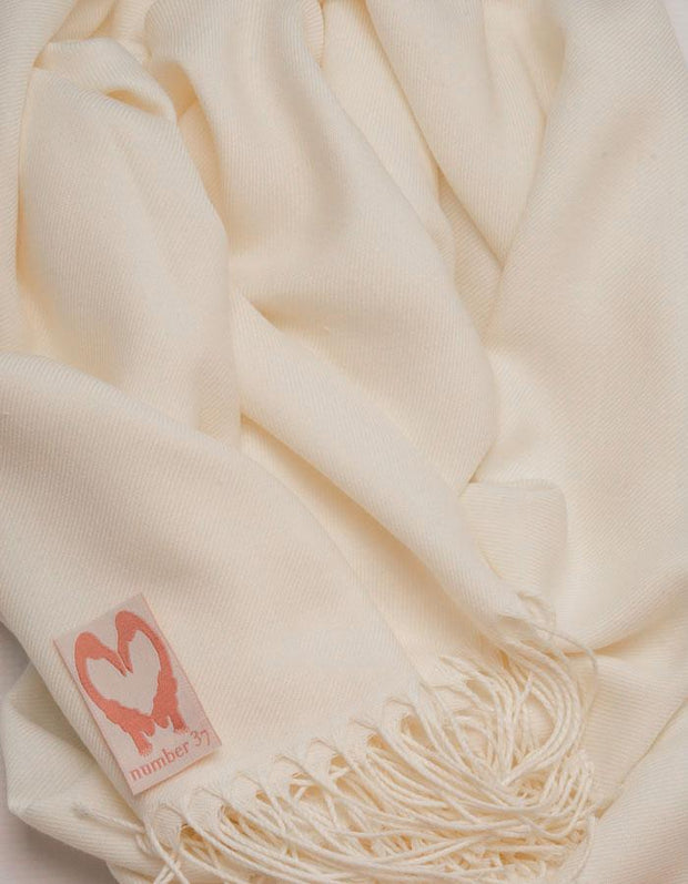 an image showing a close up view of a cream pashmina