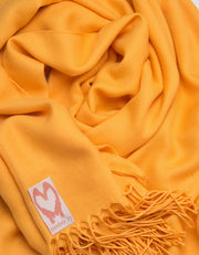 an image showing a close up of a pashmina in Amber Yellow