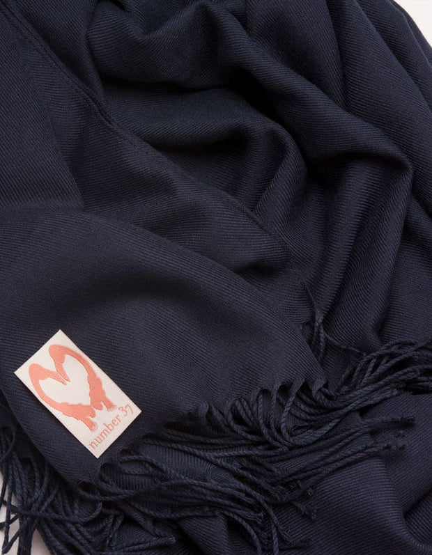 an image showing a close up of a pashmina in Navy