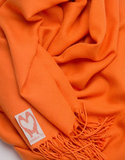 an image showing a close up of a pashmina in orange