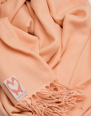 an image showing a close up of a pashmina in Peach Pink