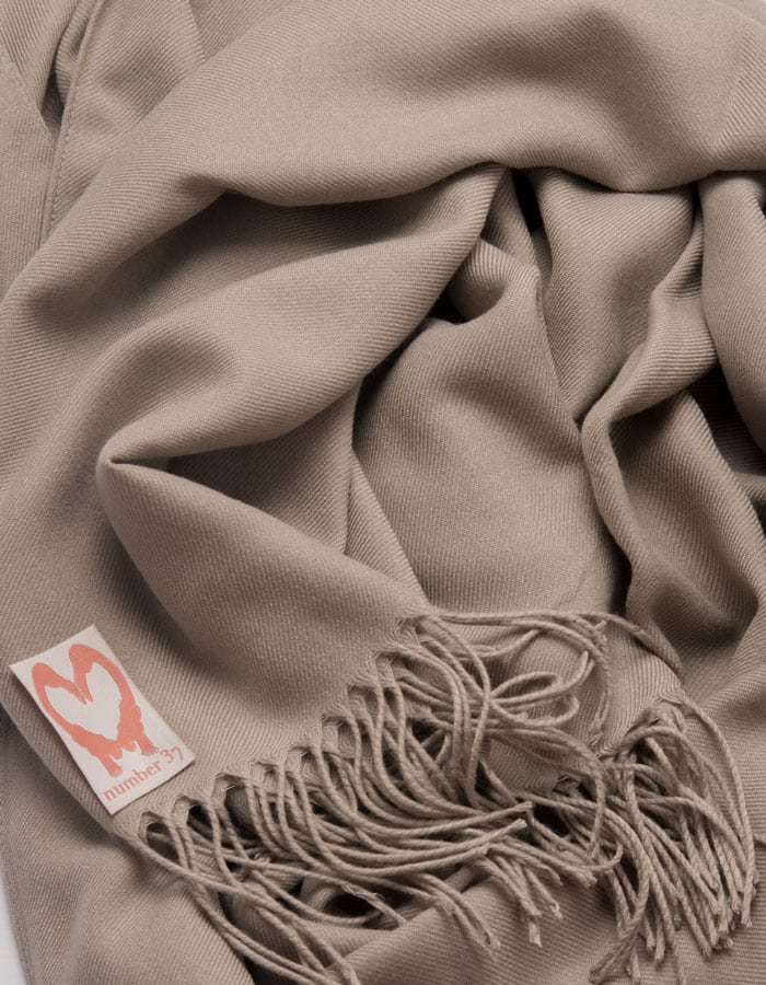 an image showing a close up of a pashmina in Taupe