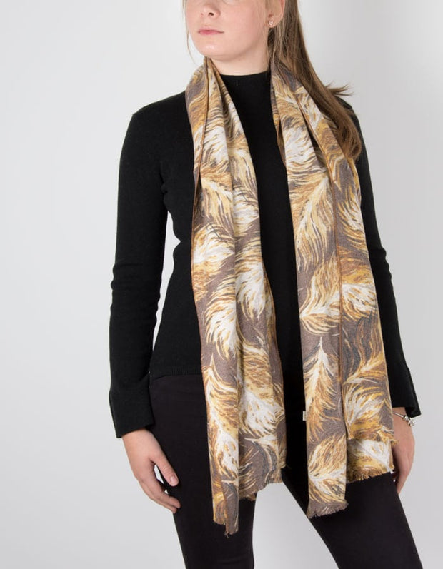 an image showing a feather print scarf in mustard