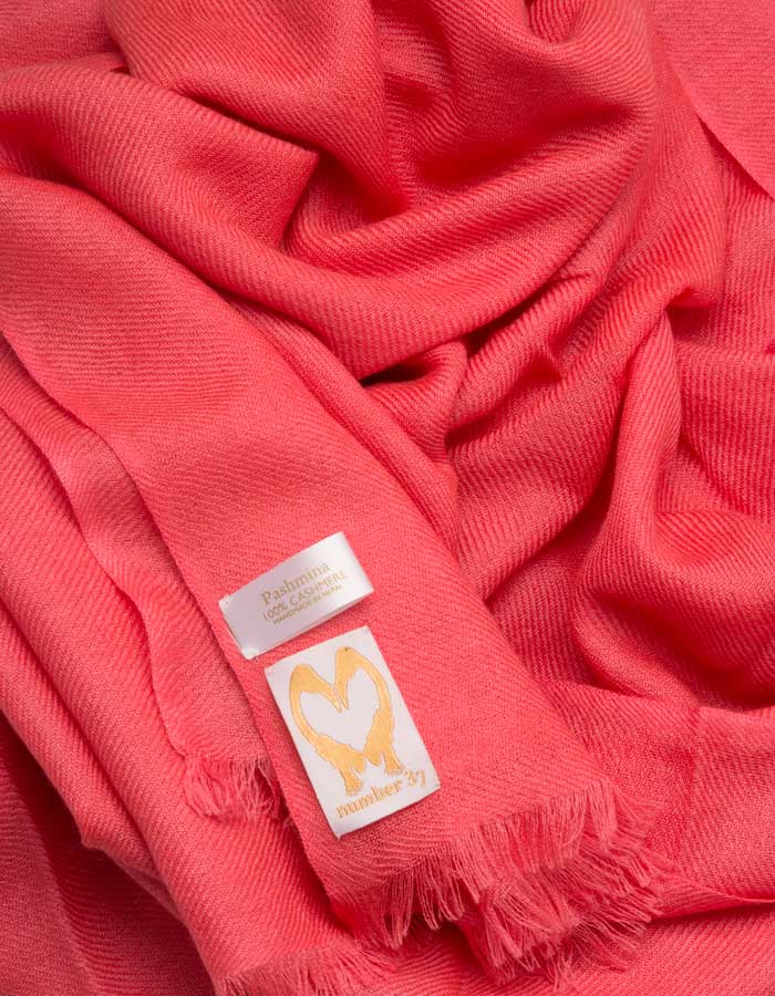 an image showing a coral cashmere pashmina scarf