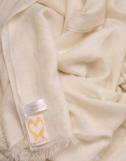 an image showing a pure cashmere pashmina scarf in ivory