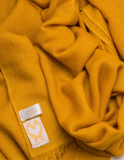 an image showing a pure cashmere pashmina in mustard