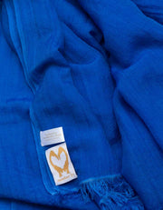 A close up image of a wool silk mix pashmina in Royal blue